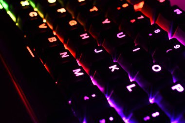 Kırmızı, mavi ve yeşil ışıkları olan düşük açılı bir bilgisayar klavyesi resmi. . 