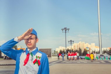 Minsk, Beyaz Rusya - 1 Mayıs 2017: Öğrenciler-öncü öncü Kravatlar ile olay kabul töreni için öncüleri için selam söyle. Ellerinde kırmızı bayraklar.
