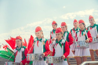 Minsk, Beyaz Rusya - 1 Mayıs 2017: Öğrenciler-öncü öncü Kravatlar ile olay kabul töreni için öncüleri için selam söyle. Ellerinde kırmızı bayraklar.