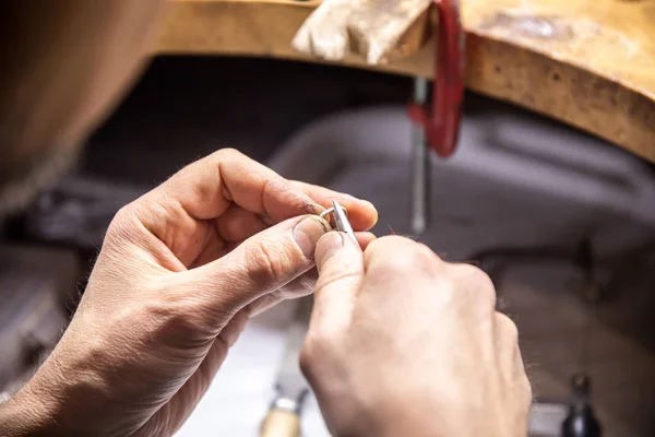 master creates a ring in the jewelry workshop