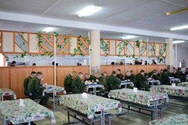MINSK, BELARUS - 3 MARCH, 2019: soldiers eat in the army canteen clipart