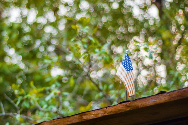 mini American flag on house