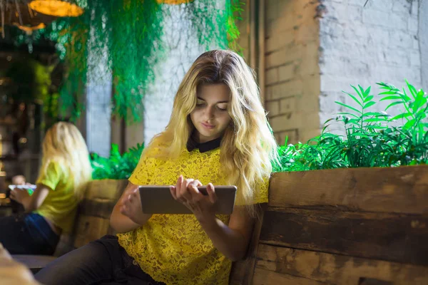 Tablet ile güzel kız bir kafede oturuyor