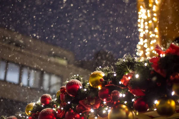 Beautiful illumination at the Christmas market during a snowfall