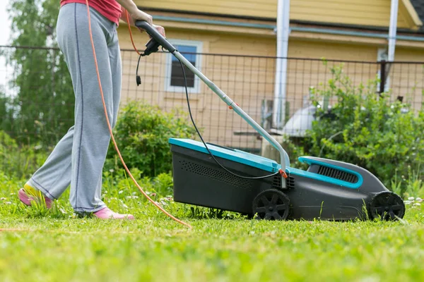 outdoor worker mowing the lawn