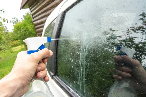 Hand Holding Plastic Spray Bottle Splashes Car Glass — Stock Photo, Image