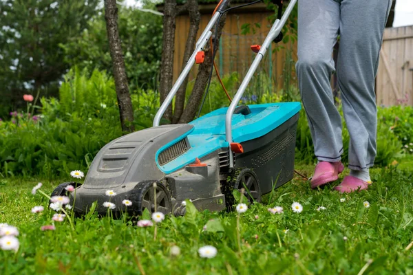 outdoor worker mowing the lawn