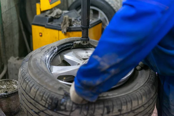 Replace tire on wheel in auto repair service
