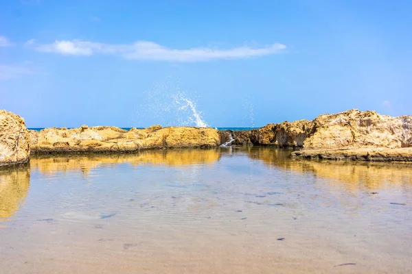 Wave splashing on the cliff