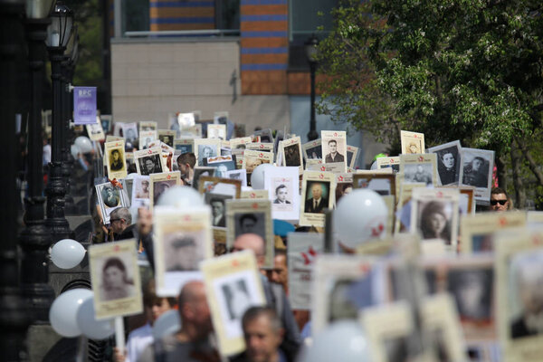 USA, New York, May 2019: People during the procession of the immortal regiment in New York, USA with portraits of their grandfathers and grandmothers who died during World War II.