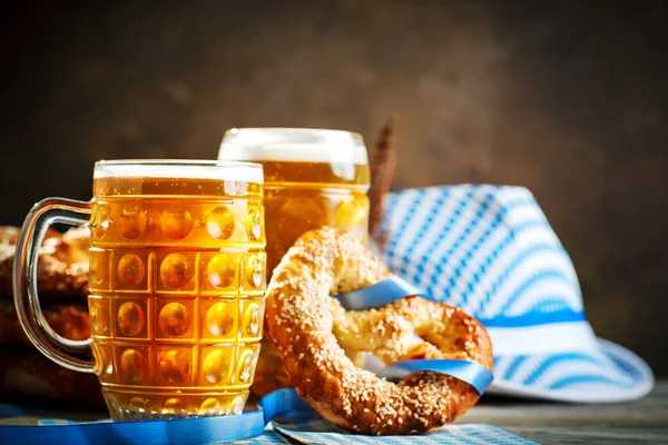 Bierpullen en pretzels op een houten tafel. Oktoberfest. Bierfestival. — Stockfoto