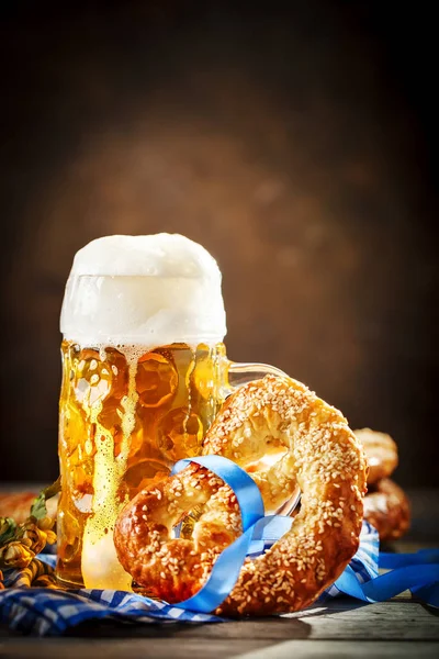 Beer mugs and pretzels on a wooden table. Oktoberfest. Beer festival.