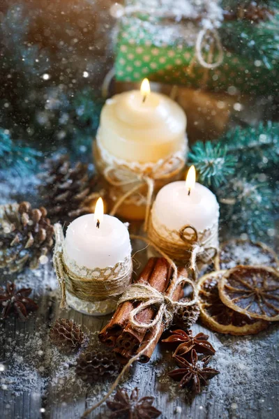 Merry Christmas and happy New year. Candle and Christmas toys on a wooden table. Bokeh. Selective focus. — Stock Photo, Image