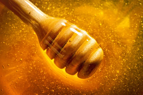 Honey with gold color flows down from a spoon. Healthy food concept. Healthy eating. Diet. Selective focus.