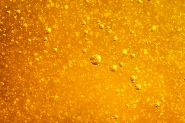 Abstract macro honey bubbles closeup in bright amber color. The texture of the honey. Healthy food concept. Diet. Selective focus. — Stock Photo, Image