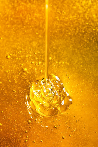 Honey with gold color flows down from a spoon. Healthy food concept. Healthy eating. Diet. Selective focus. Macro.