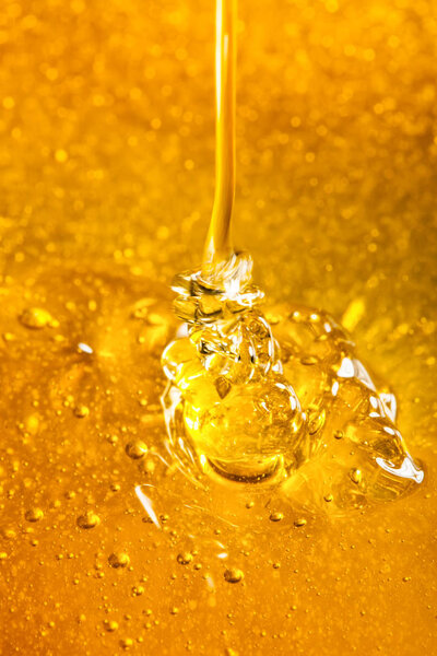 Honey with gold color flows down from a spoon. Healthy food concept. Healthy eating. Diet. Selective focus.