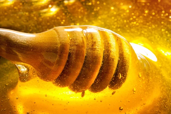 Honey with gold color flows down from a spoon. Healthy food concept. Healthy eating. Diet. Selective focus.