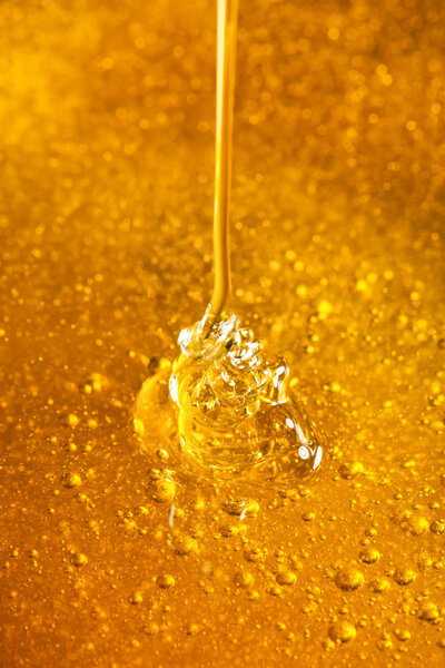Honey with gold color flows down from a spoon. Healthy food concept. Healthy eating. Diet. Selective focus. Background with copy space.