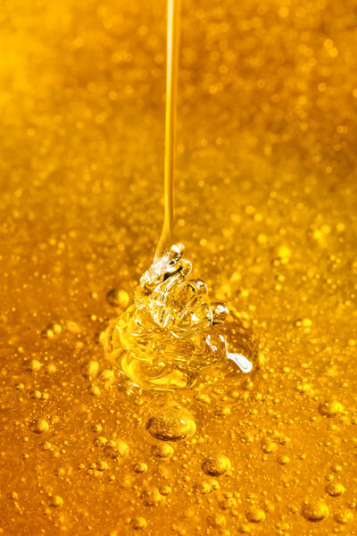 Honey with gold color flows down from a spoon. Healthy food concept. Healthy eating. Diet. Selective focus. Background with copy space.