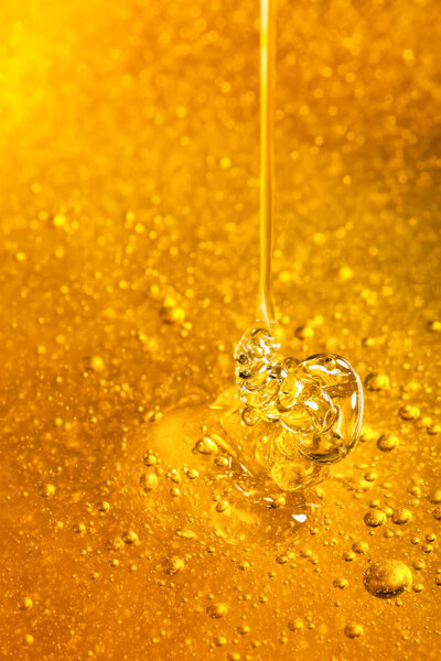 Honey with gold color flows down from a spoon. Healthy food concept. Healthy eating. Diet. Selective focus. Background with copy space.