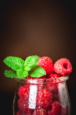 Karanlık bir arka plan üzerinde bir Fincan Ahududu. Yaz ve sağlıklı gıda konsepti. Kopyalama alanı ile arka plan. Seçici odaklama.