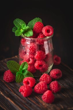 Karanlık bir arka plan üzerinde bir Fincan Ahududu. Yaz ve sağlıklı gıda konsepti. Seçici odaklama.