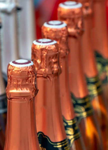 Closeup of a row of champagne bottle necks