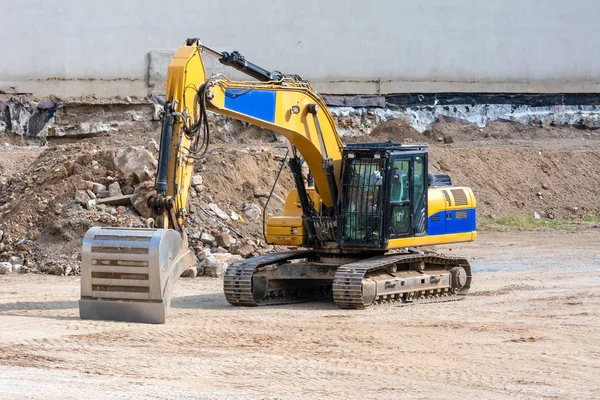 Yellow earth mover at an urban construction site