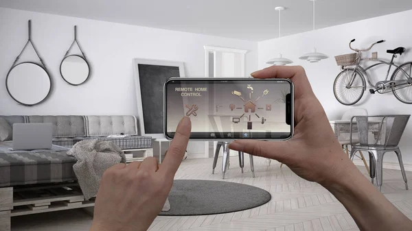 Remote home control system on a digital smart phone tablet. Device with app icons. Interior of minimalist white living room in the background, architecture design.