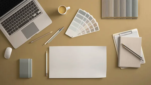 Stylish minimal office table desk. Workspace with laptop, notebook, pencils, coffee cup and sample color palette on pastel yellow background. Flat lay, top view, blank paper mockup template