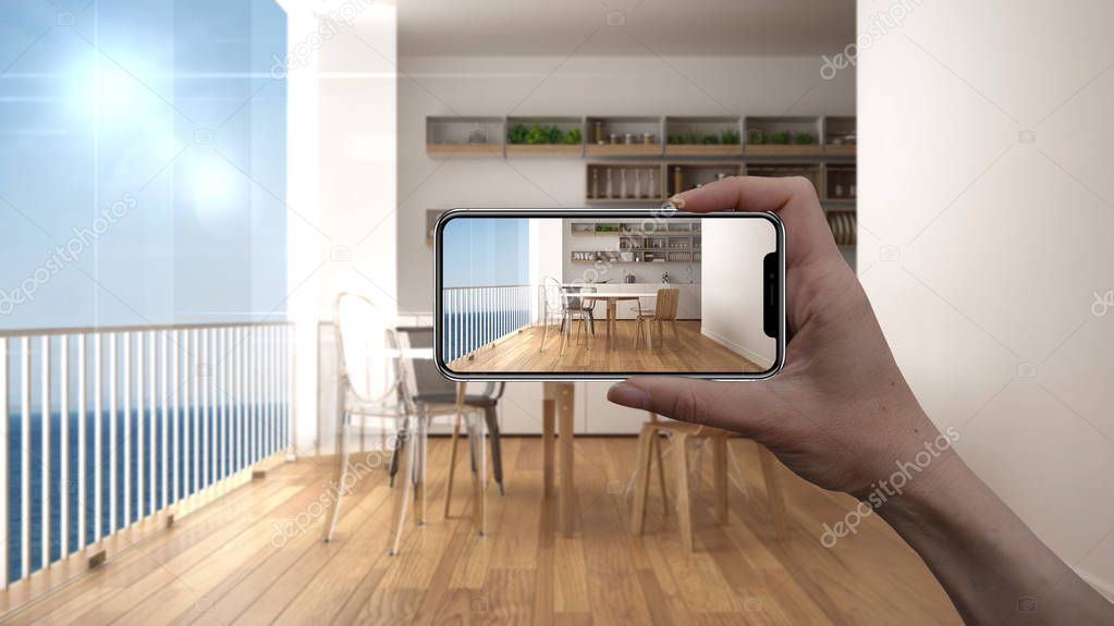 Hand holding smart phone, AR application, simulate furniture and interior design products in real home, architect designer concept, blur background, modern kitchen