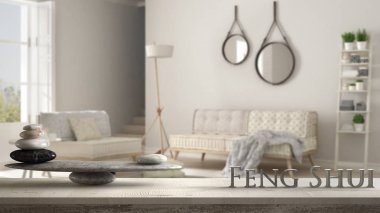 Wooden vintage table shelf with stone balance and 3d letters making the word feng shui over scandinavian living room with sofa and armchair, zen concept interior design clipart