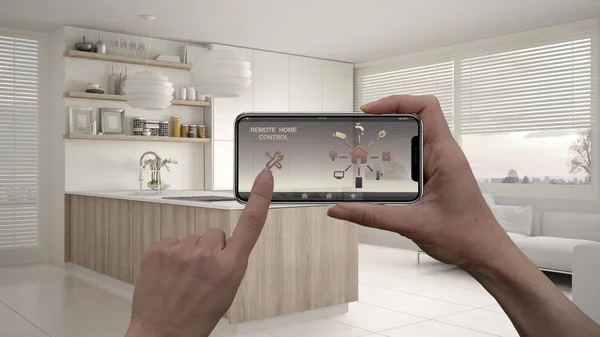 Remote home control system on a digital smart phone tablet. Device with app icons. Interior of modern kitchen with shelves and cabinets in the background, architecture design