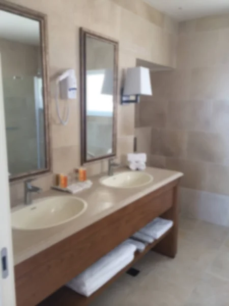 Blur interior design, bathroom closeup, marble sink, mirror, lamps and accessories