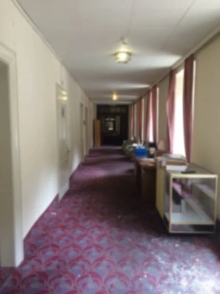 Blur interior design, hotel hall corridor, classic style with carpeting, pendant lamps and windows with curtains
