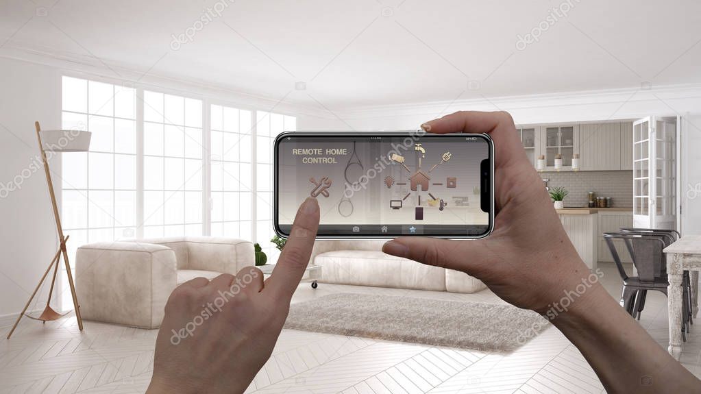 Remote home control system on a digital smart phone tablet. Device with app icons. Interior of minimalist scandinavian living room with kitchen in the background, architecture design