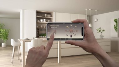 Uzaktan ev kontrol sistemi dijital akıllı telefon tablet. Aygıt app simgeleri ile. İç mimari tasarım arka planda minimalist beyaz ve ahşap mutfak
