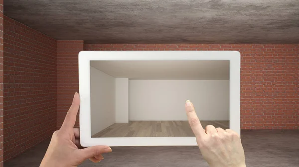 Augmented reality concept. Hand holding tablet with AR application used to simulate furniture and design products in an interior construction site, empty interior with parquet floor