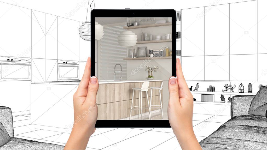 Hands holding tablet showing modern white and wooden kitchen. Blueprint CAD sketch background, augmented reality concept, application to simulate furniture and interior design products