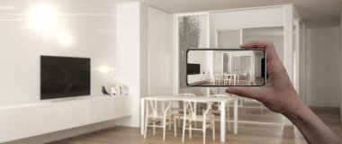 El tutan akıllı telefon, Ar uygulaması, gerçek evde mobilya ve iç tasarım ürünleri simüle, mimar tasarımcı kavramı, bulanıklık arka plan, modern minimalist oturma odası