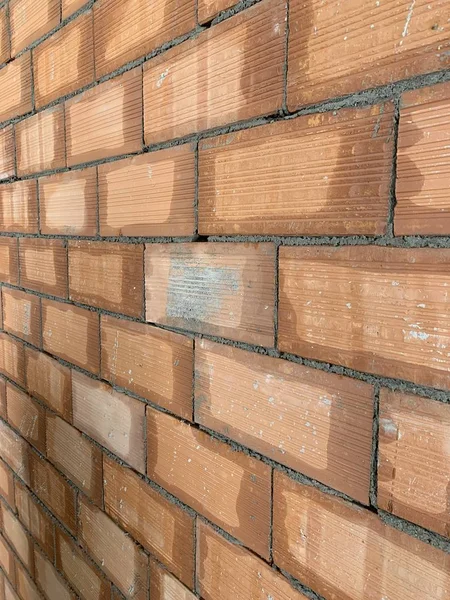 Red brick texture. Large red brick wall, european brickwork with natural defects, scratches, cracks, crevices, chips, dust, roughness