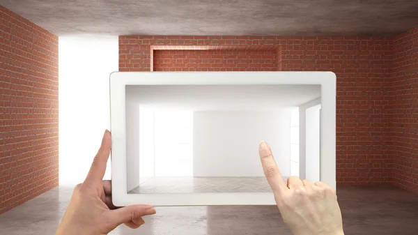 Концепция дополненной реальности. Ручной планшет с приложением AR для имитации мебели и дизайнерских изделий на строительной площадке интерьера, пустой интерьер с паркетным полом — стоковое фото