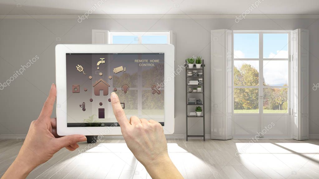 Smart remote home control system on a digital tablet. Device with app icons. Minimalist stylish empty room with panoramic windows in the background, architecture interior design