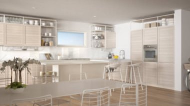 Bulanıklık arka plan iç tasarım, penthouse minimalist mutfak iç tasarım, yemek masası, tabureler, parke ile ada. Modern mimari kavram fikri