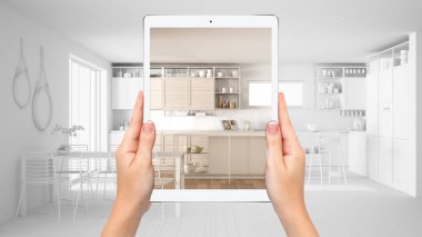 Modern beyaz ve ahşap mutfak gösteren eller tutma tablet, toplam boş proje arka plan, artırılmış gerçeklik konsepti, uygulama mobilya ve iç tasarım ürünleri simüle etmek