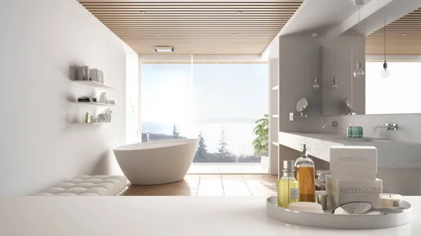 Spa, hotel bathroom concept. White table top or shelf with bathing accessories, toiletries, over blurred wooden minimalist bathroom, modern architecture interior design