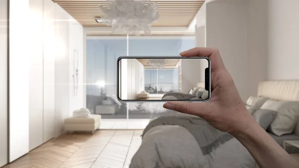 Hand holding smart phone, AR application, simulate furniture and interior design products in real home, architect designer concept, blur background, modern bedroom with bed and shower