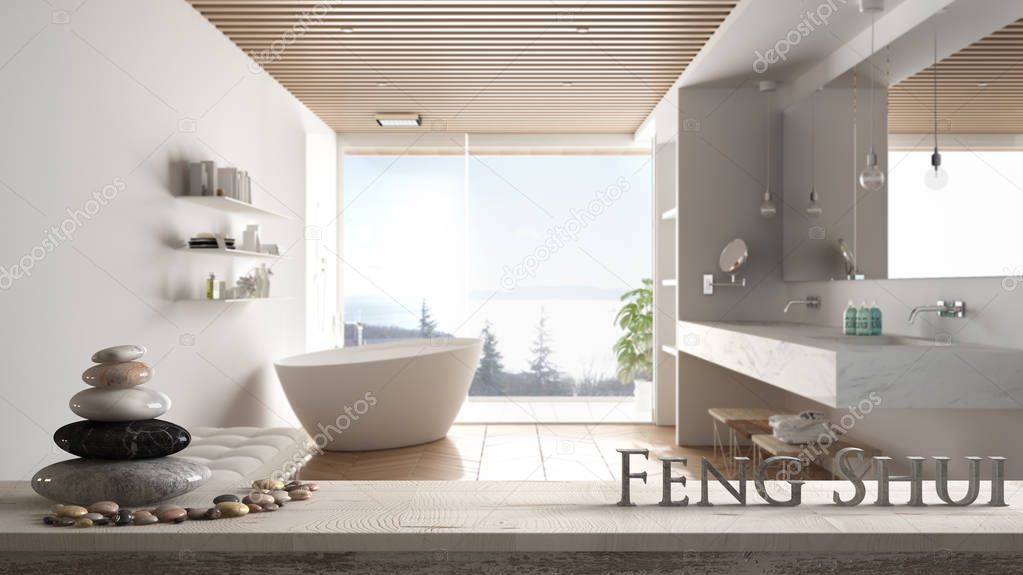 Wooden vintage table shelf with pebble balance and 3d letters making the word feng shui over blurred minimalist luxury bathroom with bathtub and shower, zen concept interior design