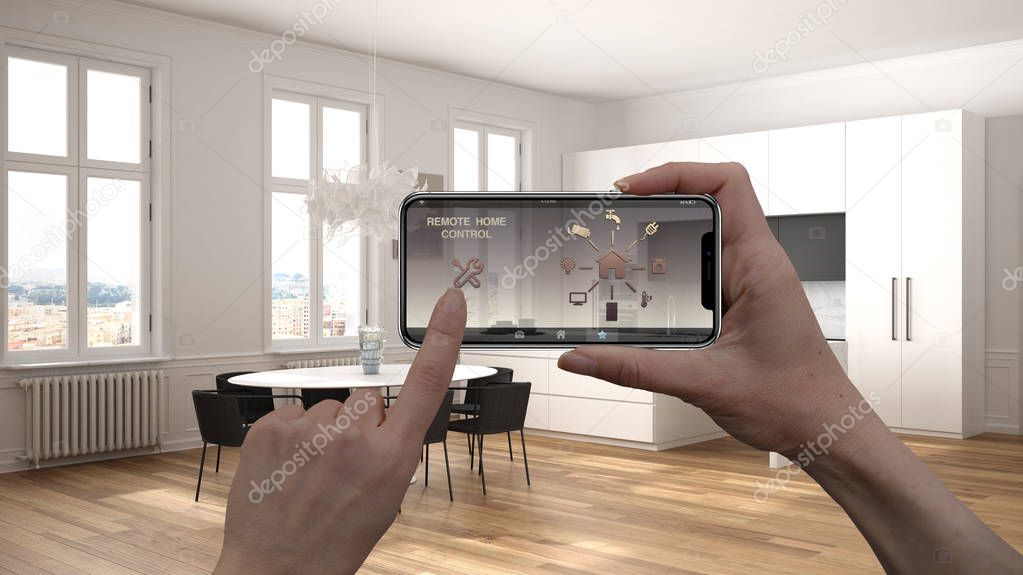 Remote home control system on a digital smart phone tablet. Device with app icons. Interior of minimalist kitchen with dining table in the background, architecture design, top view